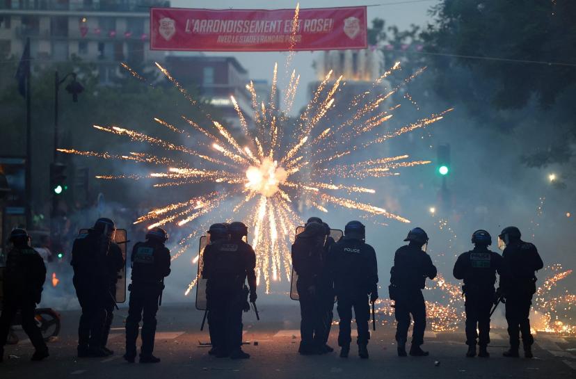 Feux d’artifice et interventions des forces de l’ordre sur les Champs-Élysées à Paris.